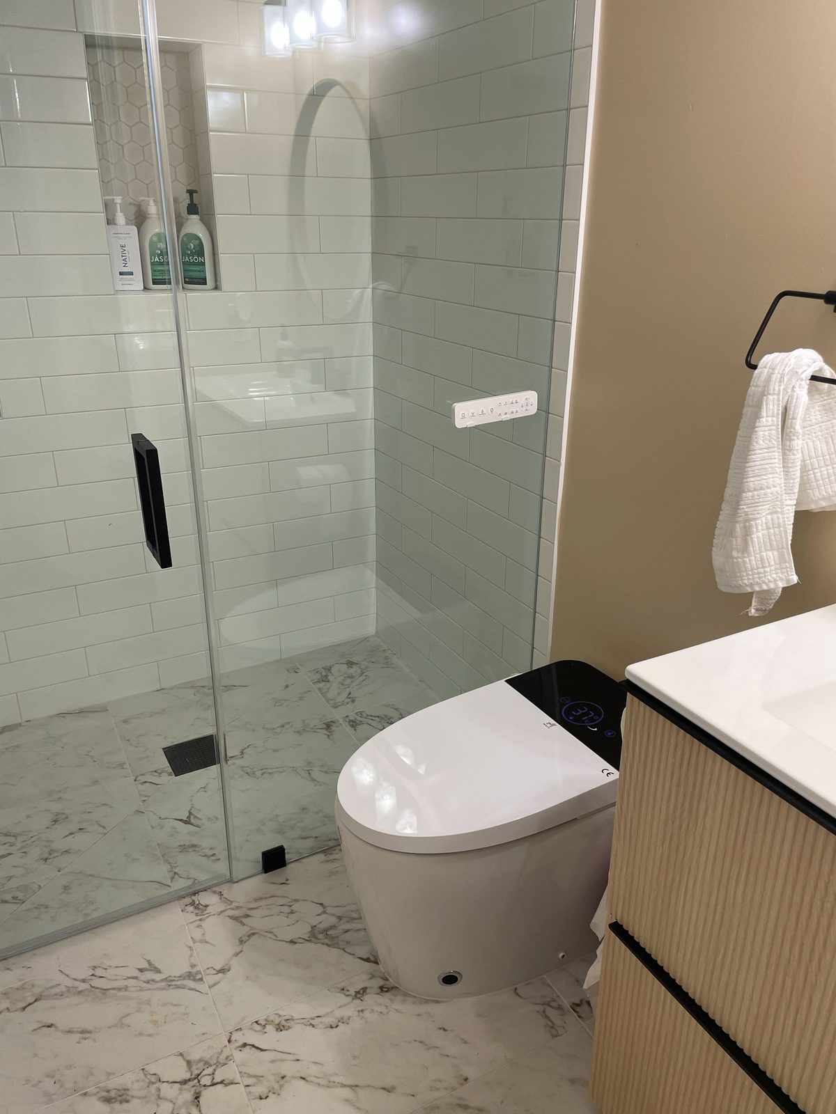Bathroom with smart toilet and wood vanity