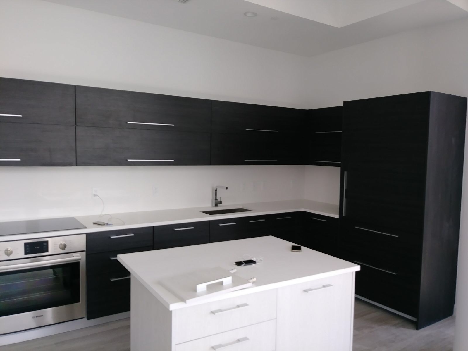 Modern dark cabinet kitchen with white island